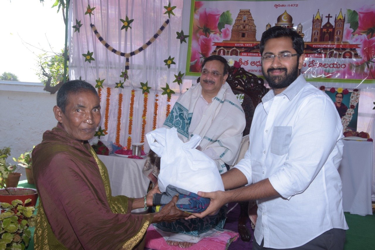 Sri M.Bharat (Geetham Institutes Chairman, Vishakapatnam) distributing saree and rice to poor women  on the occasion of 18thAnniversary of Bheemili Ashram