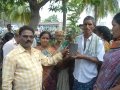 150 plants were distributed , members showing the plant they received on the occasion of Guru Pournami
